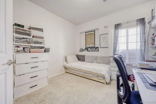a view of a workspace with furniture and a bookshelf