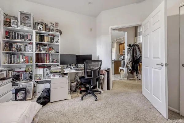 a view of an empty room with cabinet and white cabinet