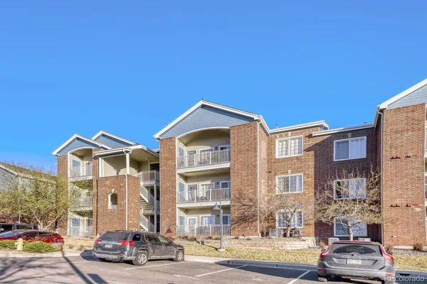 a kitchen with stainless steel appliances granite countertop a stove a sink a microwave cabinets and dining table