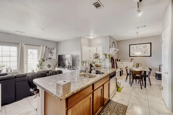 a living room with lots of furniture and kitchen view