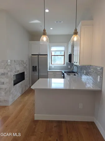 a large kitchen with kitchen island a sink stainless steel appliances and cabinets