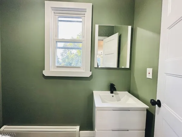 a bathroom with a sink and a window