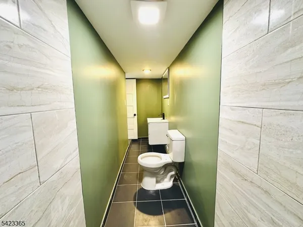 a bathroom with a toilet and a mirror