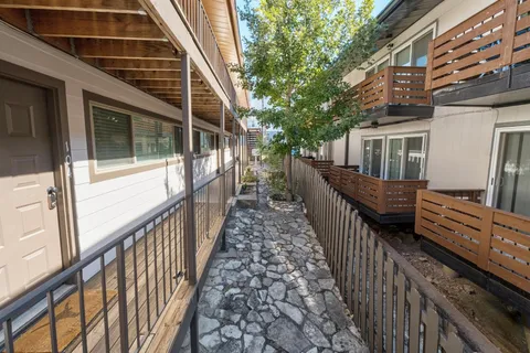 a view of a house with wooden deck