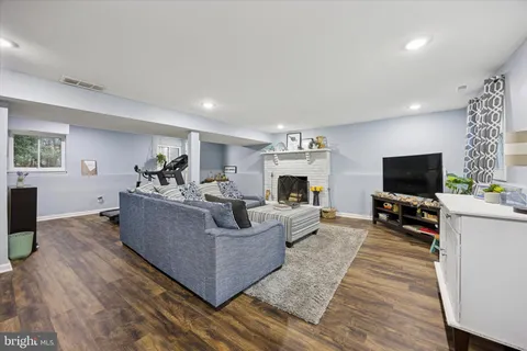 a room with gym equipment and wooden floor