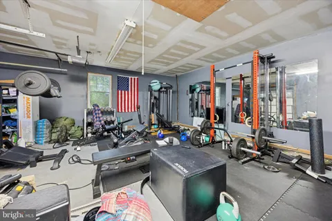 a backyard of a house with wooden floor and outdoor seating