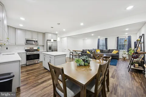 a large kitchen with a table and chairs