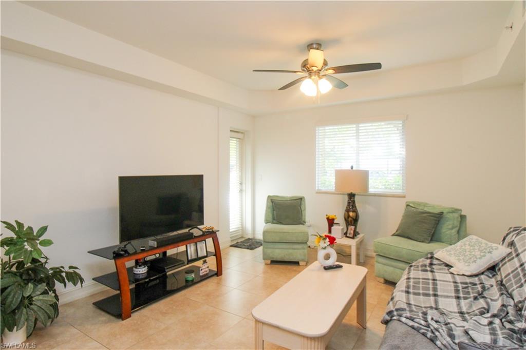 1100 Pine Ridge Road, Unit 105B Naples, FL 34108 - Photo 7 of 11 Living room with ceiling fan and light tile patterned flooring