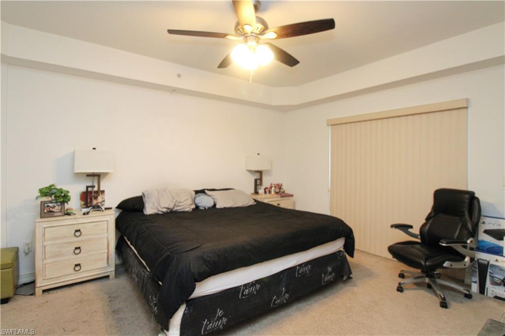 1100 Pine Ridge Road, Unit 105B Naples, FL 34108 - Photo 8 of 11 Carpeted bedroom with ceiling fan