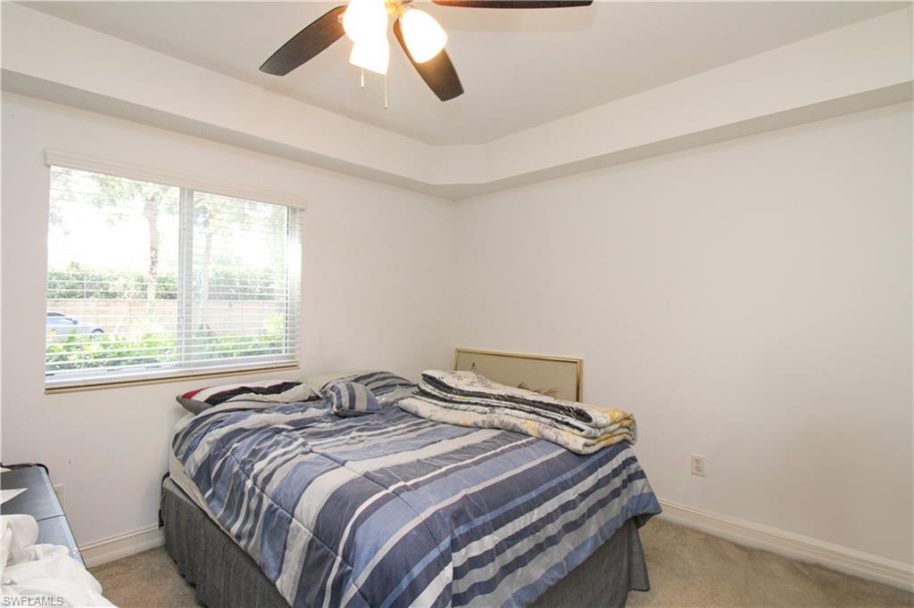 1100 Pine Ridge Road, Unit 105B Naples, FL 34108 - Photo 10 of 11 Bedroom with carpet flooring and ceiling fan