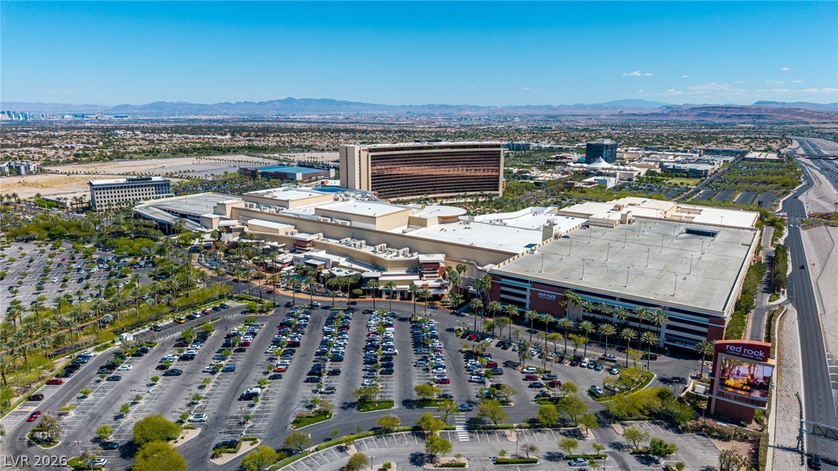 2153 Quarry Ridge Street, Unit 103 Las Vegas, NV 89117 - Photo 42 of 42 An aerial panorama reveals a vast commercial complex, extensive parking facilities, and distant desert mountains.