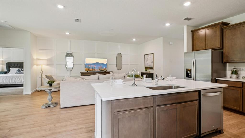 4542 Northwest 39th St Road Ocala, FL 34482 - Photo 6 of 28 a view of kitchen island a sink wooden floor and a living room