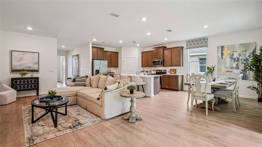 4542 Northwest 39th St Road Ocala, FL 34482 - Photo 9 of 28 a living room with furniture flat screen tv and kitchen view