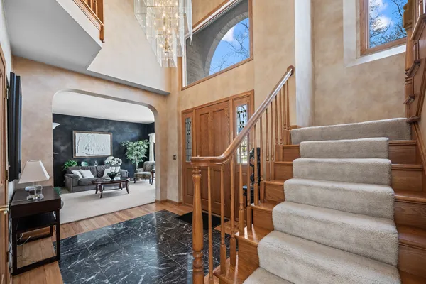 a view of entryway and hall with wooden floor