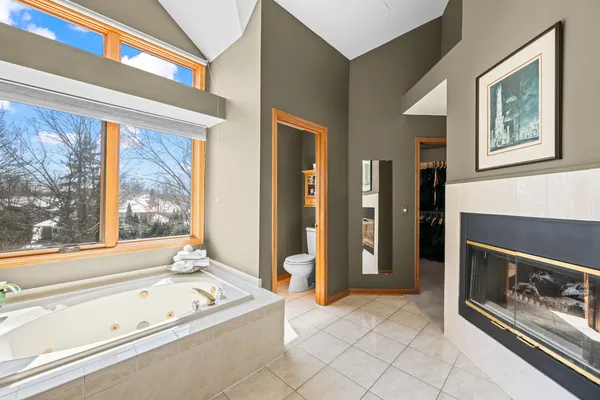 a living room with stainless steel appliances furniture and a large window