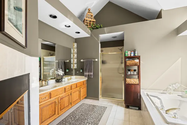 a large white kitchen with a sink a refrigerator and a stove