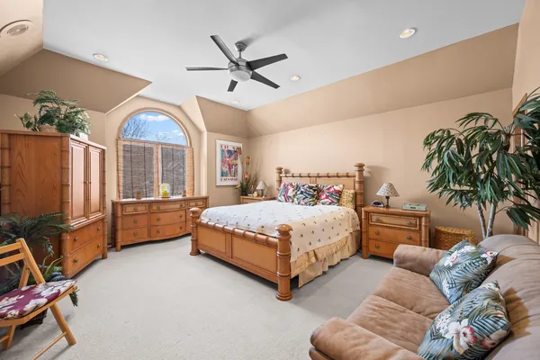 a bedroom with a bed window and couch