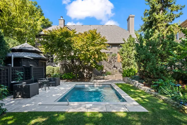 a backyard of a house with table and chairs