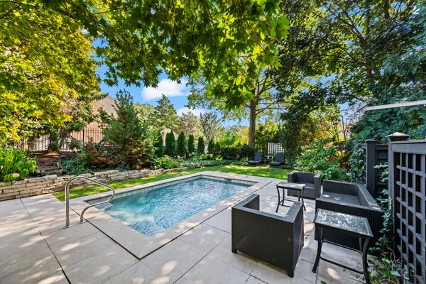 a view of a backyard with swimming pool