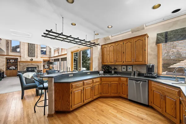 a kitchen with lots of counter top space and wooden floor