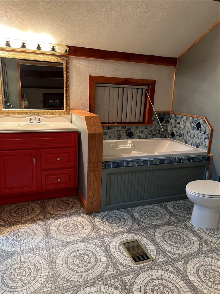 29716 Jackson Street Castaic, CA 91384 - Photo 33 of 38 a bathroom with a sink a toilet and mirror