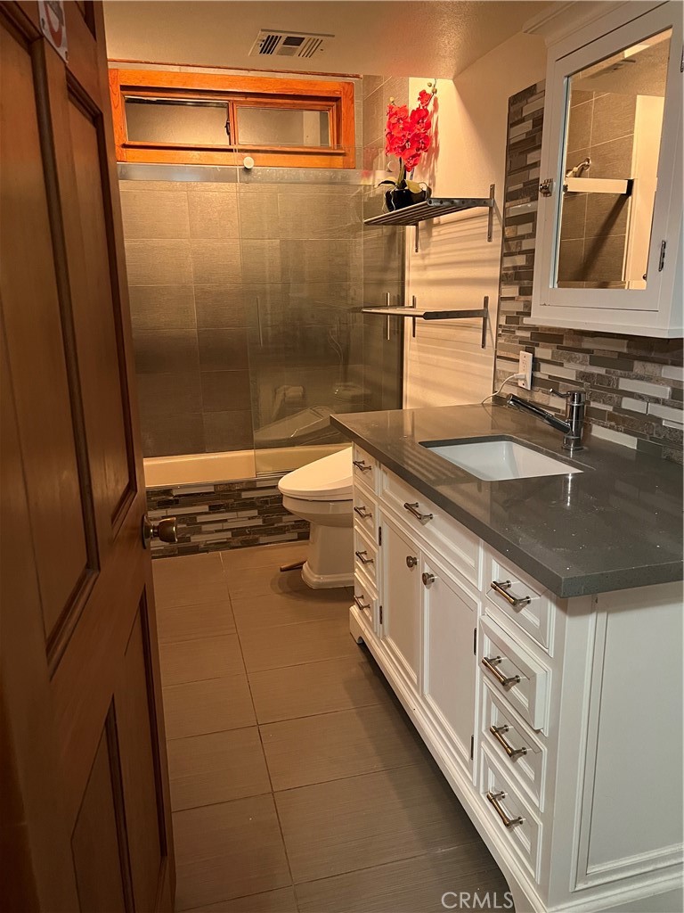 29716 Jackson Street Castaic, CA 91384 - Photo 35 of 38 a bathroom with a granite countertop sink mirror vanity and toilet