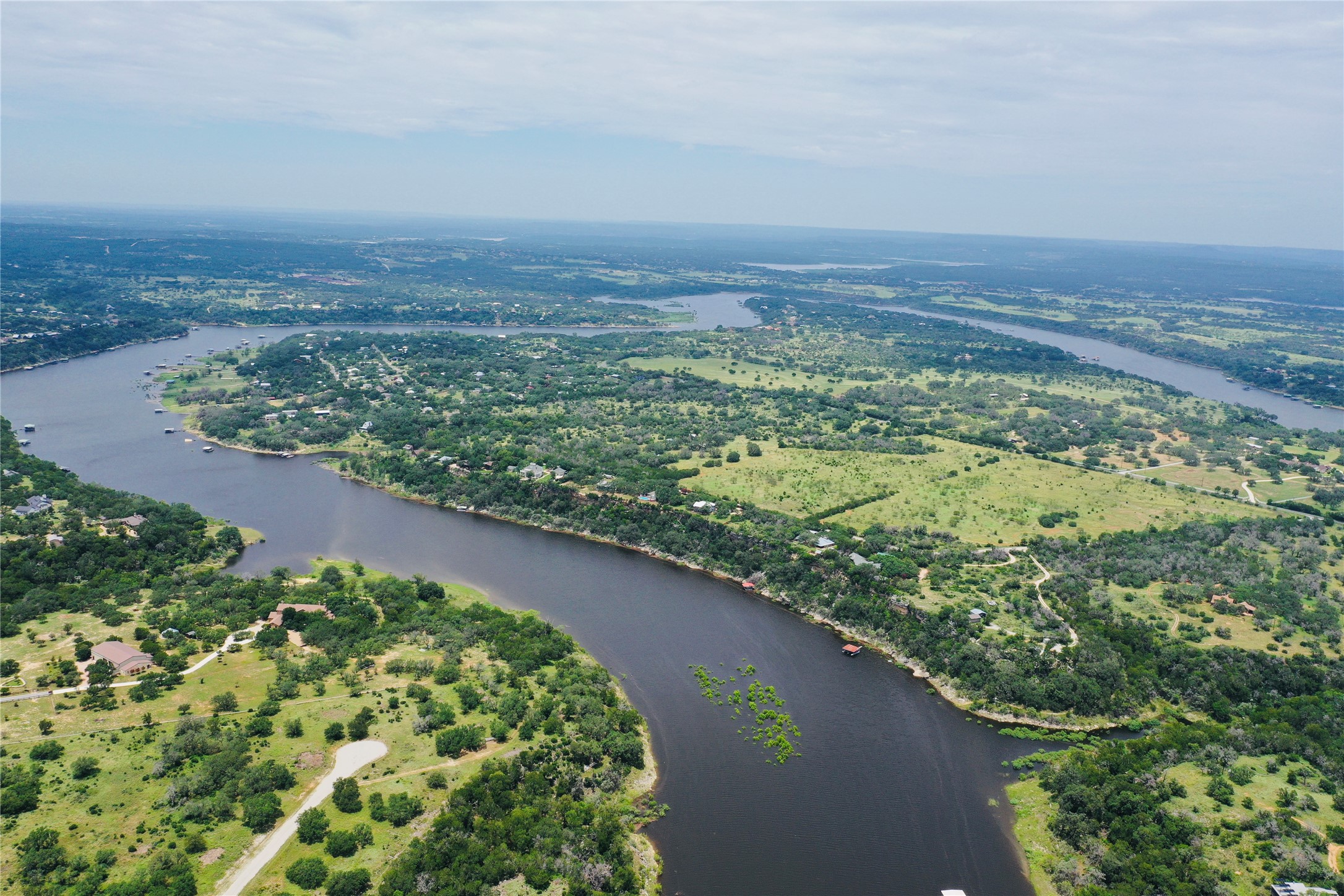 23601 Old Ferry Road, Unit 1 Spicewood, TX 78669 - Photo 4 of 33 an aerial view of a residential houses with outdoor space