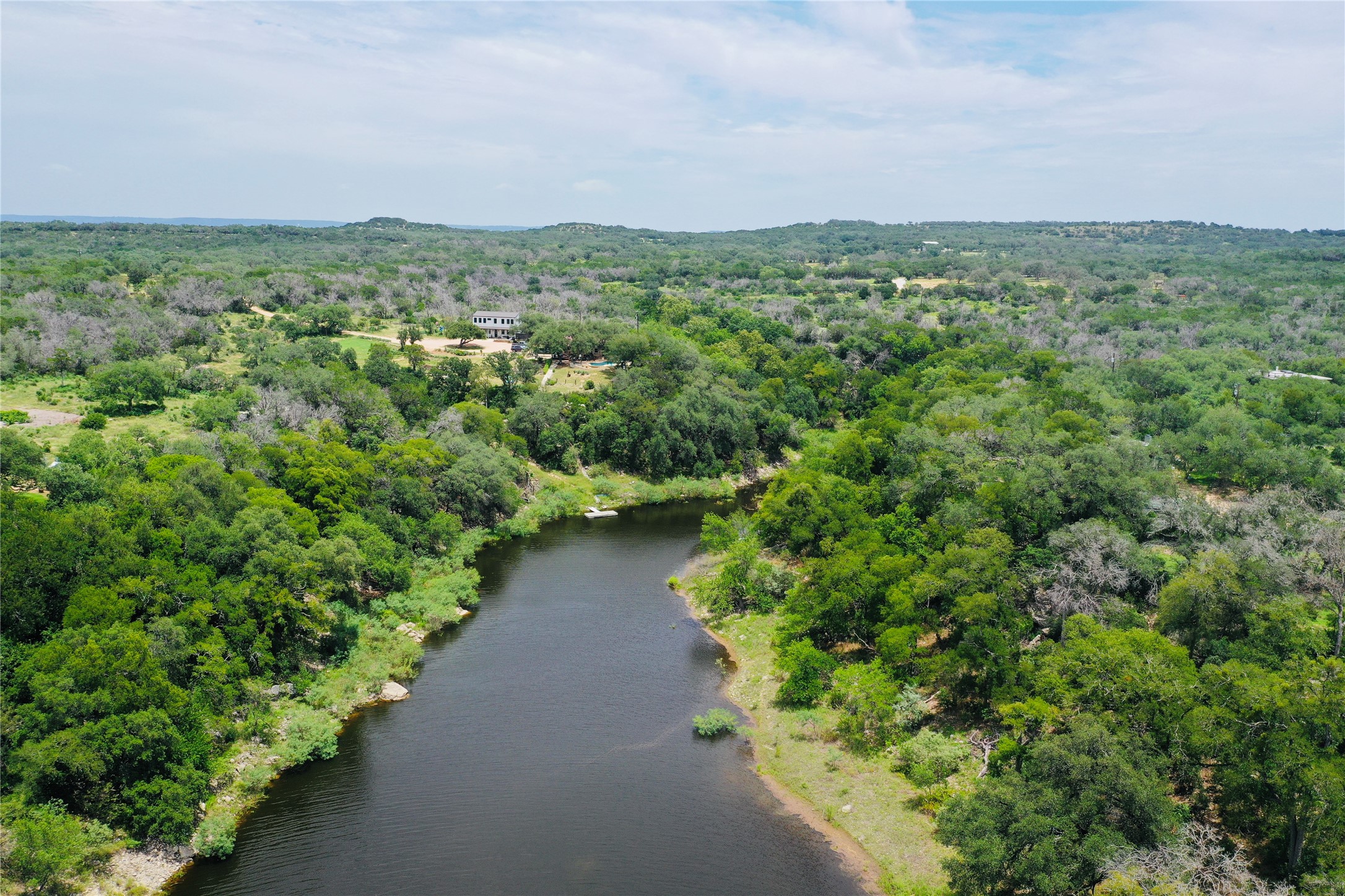 23601 Old Ferry Road, Unit 1 Spicewood, TX 78669 - Photo 7 of 33 a view of a green field with lots of bushes