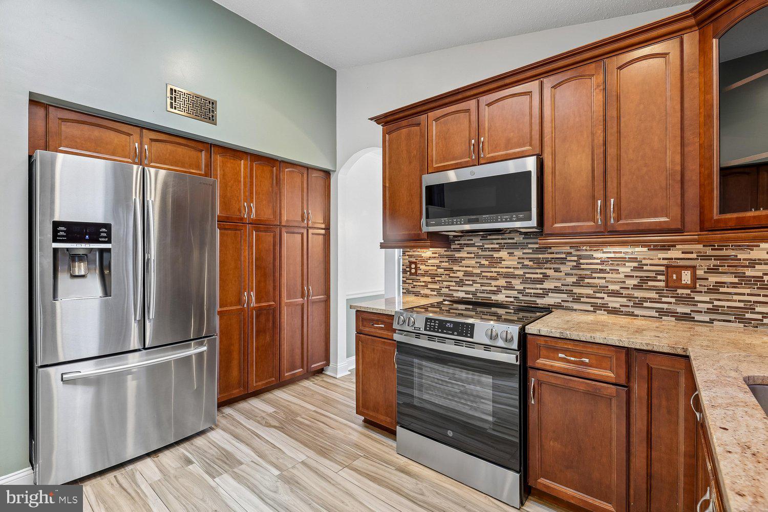 15764 Beau Ridge Drive Woodbridge, VA 22193 - Photo 11 of 58 a kitchen with granite countertop stainless steel appliances and wooden cabinets