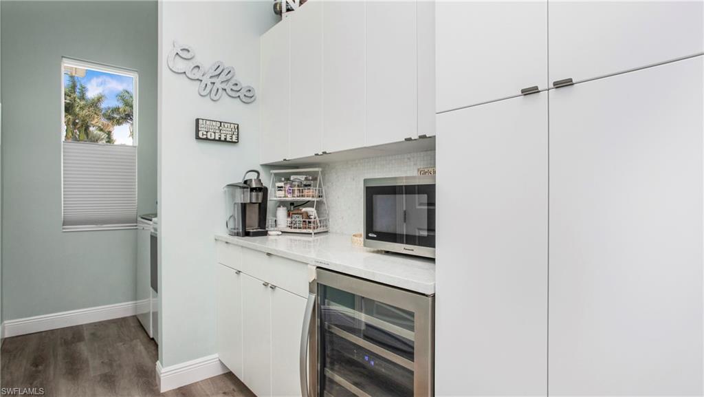 162 Windward Cay Naples, FL 34114 - Photo 12 of 35 a kitchen with stainless steel appliances a refrigerator and cabinets