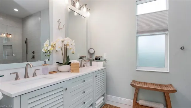 a bathroom with a double vanity sink and a mirror