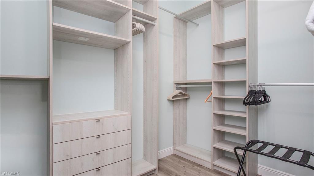 162 Windward Cay Naples, FL 34114 - Photo 27 of 35 a view of walk in closet with empty racks