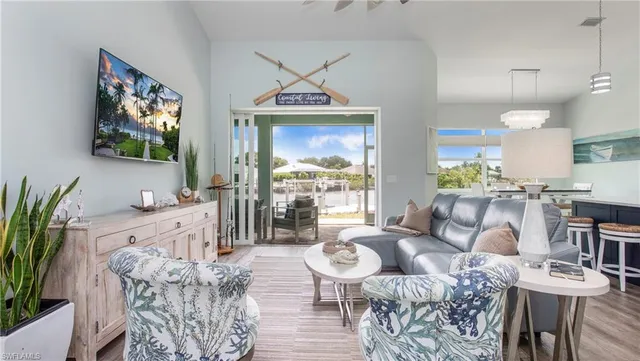 a living room with furniture a flat screen tv and a large window