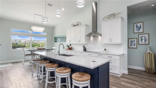 a kitchen with a table chairs stove and cabinets