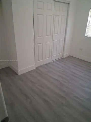 an empty room with wooden floor
