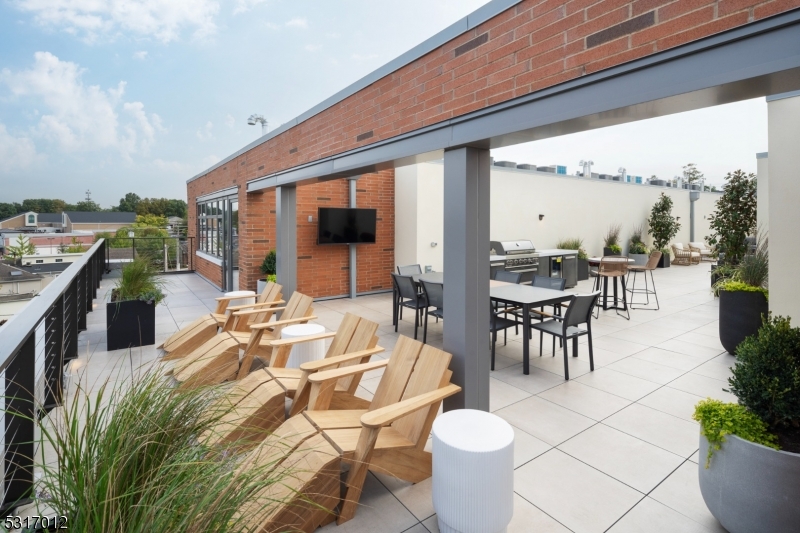 14 Lincoln Place, Unit 208 Madison, NJ 07940 - Photo 12 of 17 a view of a patio with chairs and tables