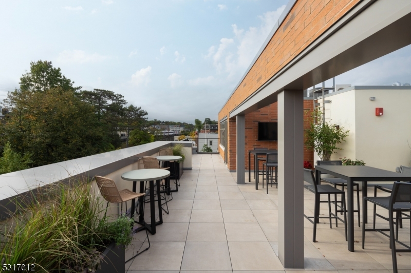 14 Lincoln Place, Unit 208 Madison, NJ 07940 - Photo 13 of 17 a view of a patio with table and chairs and potted plants