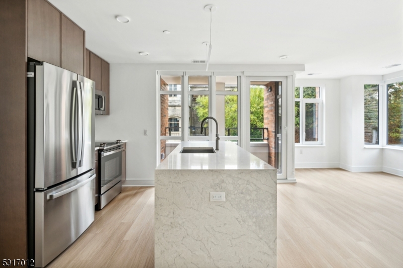 14 Lincoln Place, Unit 208 Madison, NJ 07940 - Photo 3 of 17 a view of a kitchen with refrigerator and windows