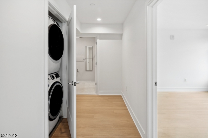 14 Lincoln Place, Unit 208 Madison, NJ 07940 - Photo 6 of 17 a view of a hallway with washer and dryer