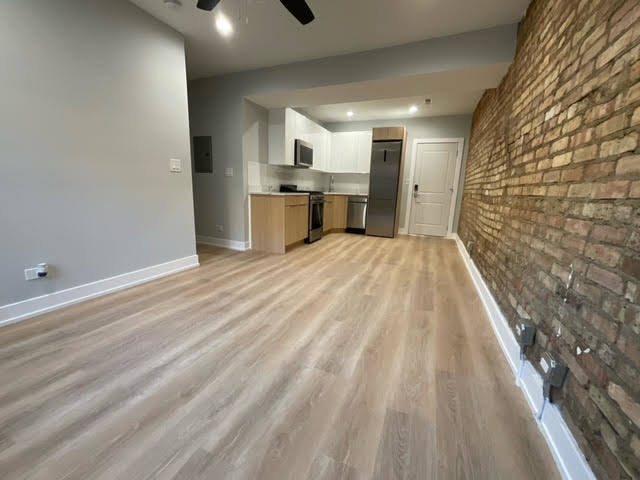 1552 West Juneway Terrace, Unit 2F Chicago, IL 60626 - Photo 2 of 9 a view of kitchen with wooden floor