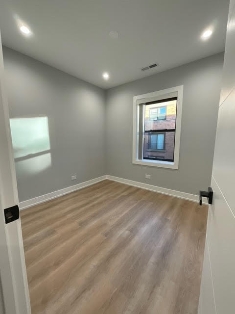 1552 West Juneway Terrace, Unit 2F Chicago, IL 60626 - Photo 4 of 9 an empty room with windows