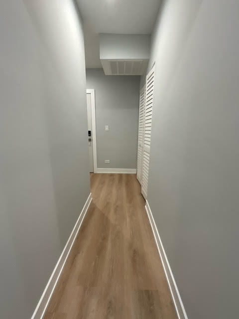 1552 West Juneway Terrace, Unit 2F Chicago, IL 60626 - Photo 5 of 9 a view of a hallway with wooden floor
