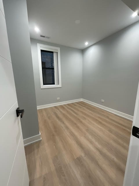 1552 West Juneway Terrace, Unit 2F Chicago, IL 60626 - Photo 7 of 9 an empty room with windows