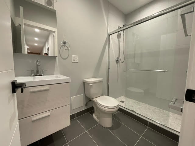 1552 West Juneway Terrace, Unit 2F Chicago, IL 60626 - Photo 8 of 9 a bathroom with a sink toilet and shower