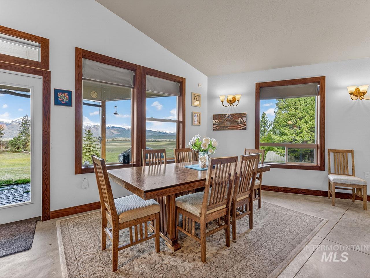 10885 Callender Road Cascade, ID 83611 - Photo 13 of 31 Dining area with multiple large windows featuring wood-finish trim, offering expansive outdoor scenery