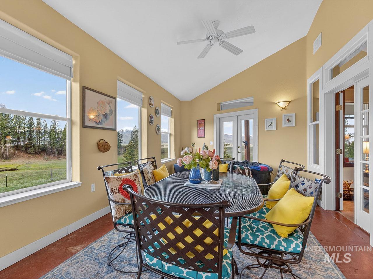 10885 Callender Road Cascade, ID 83611 - Photo 21 of 31 Sunroom featuring expansive windows, vaulted ceiling, and dual French doors