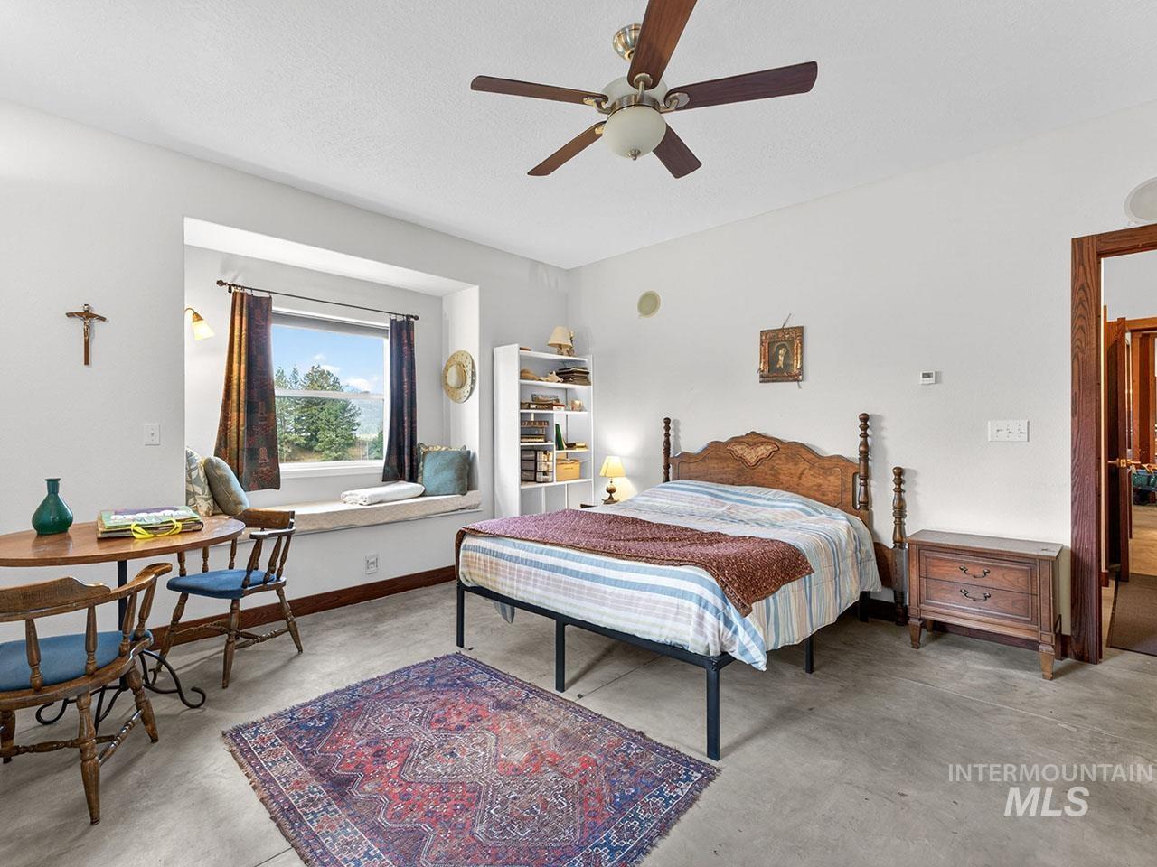 10885 Callender Road Cascade, ID 83611 - Photo 27 of 31 Spacious room featuring concrete flooring, a wide window seat, and built-in shelving