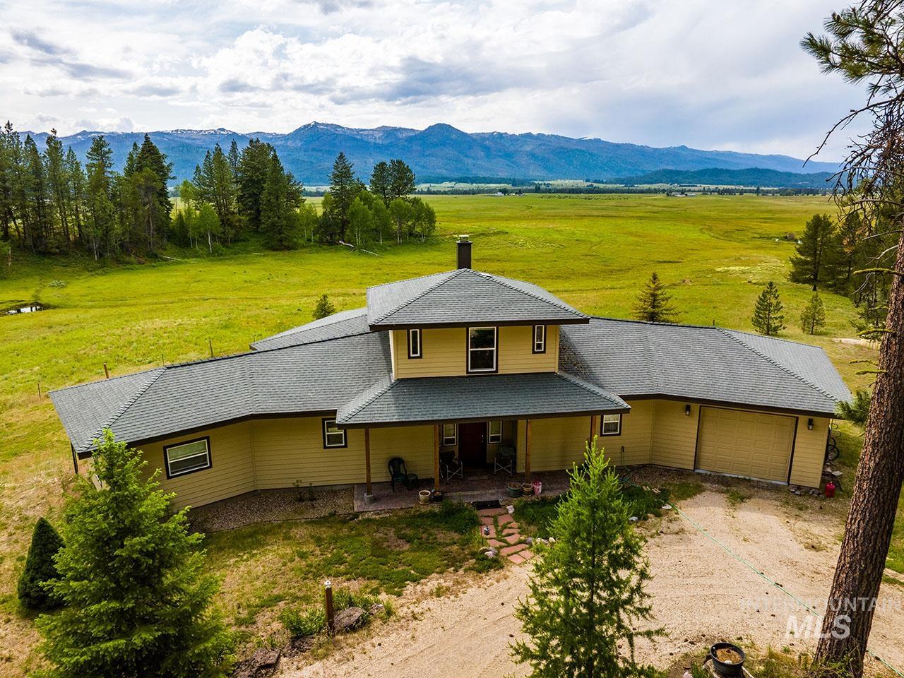 10885 Callender Road Cascade, ID 83611 - Photo 5 of 31 Expansive property featuring a multi-level residence with a gray shingle roof and light yellow siding