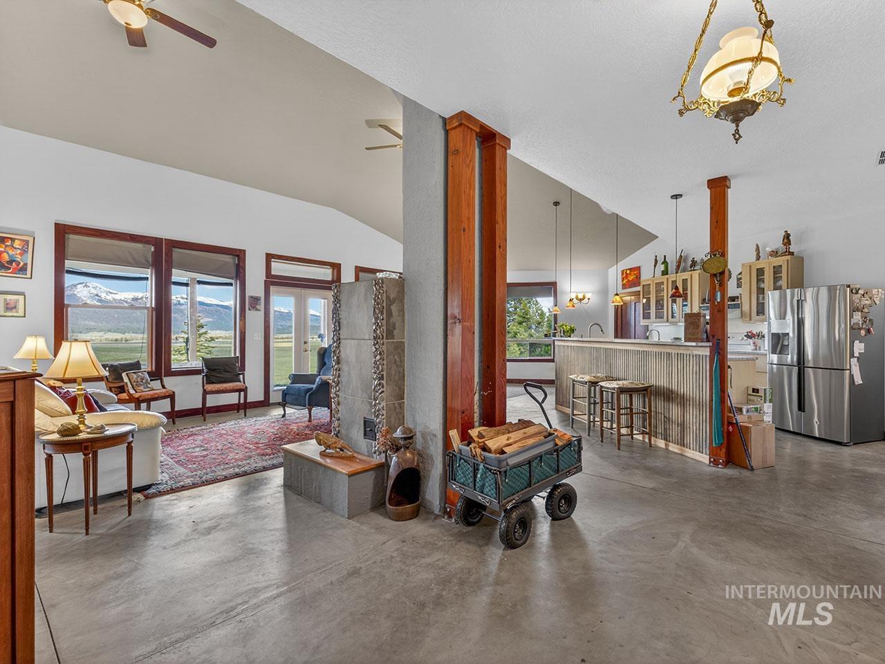 10885 Callender Road Cascade, ID 83611 - Photo 10 of 31 Vaulted ceilings and polished concrete flooring define this open-concept living area