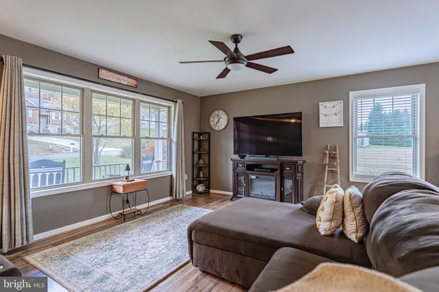 a living room with a bed furniture and a large window